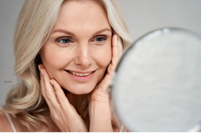 Woman looking in mirror